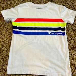 This is a white tee shirt with different colored lines and it says champion